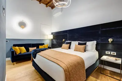 a bedroom with a large bed and a couch at Glamour Studio - Spanish Steps in Rome