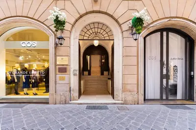 a store front with two arched windows and a door at Glamour Studio - Spanish Steps in Rome