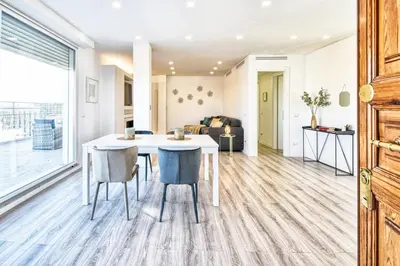 a kitchen and living room with a table and chairs at St. Peter penthouse in Rome