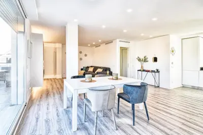 a living room with a white table and chairs at St. Peter penthouse in Rome
