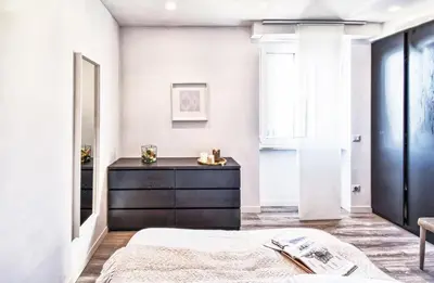 a bedroom with a black dresser and a mirror at St. Peter penthouse in Rome
