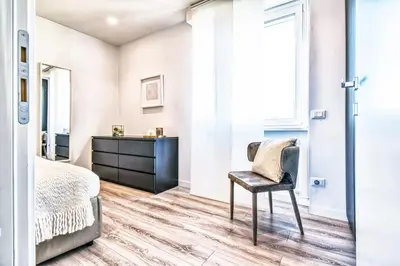 a bedroom with a bed and a chair at St. Peter penthouse in Rome