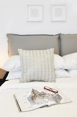 a book and a pair of glasses on a bed at St. Peter penthouse in Rome
