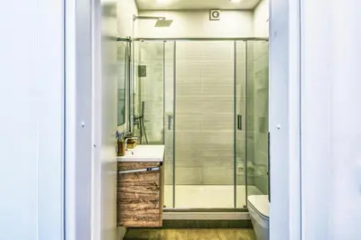 a bathroom with a shower and a sink and a toilet at St. Peter penthouse in Rome