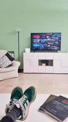 a persons feet on the floor in a living room with a tv at STEFY ROME APARTMENT in Rome