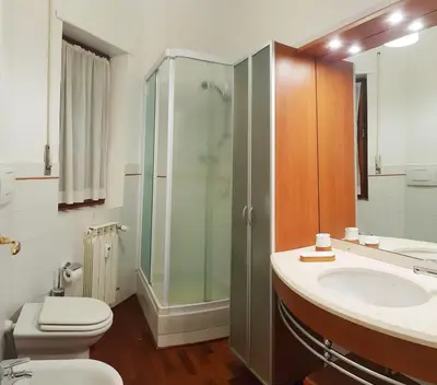 a bathroom with a shower and a toilet and a sink at STEFY ROME APARTMENT in Rome