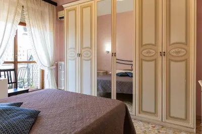 a bedroom with a bed and a large closet at Bed and Breakfast La Stazione Del Vaticano in Rome