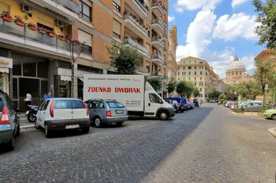 a moving truck parked on the side of a street at Bed and Breakfast La Stazione Del Vaticano in Rome