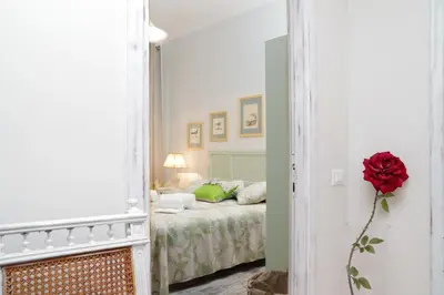 a bedroom with a bed and a red rose in a mirror at Restart Accommodations Rome in Rome