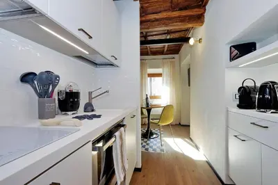 a kitchen with white cabinets and a counter top at Restart Accommodations Rome in Rome