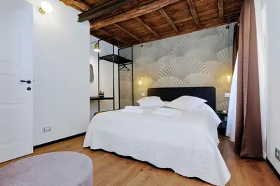 a bedroom with a large bed with white sheets and pillows at Restart Accommodations Rome in Rome