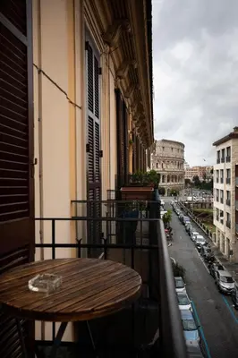 a table on a balcony with a view of a city at Restart Accommodations Rome in Rome