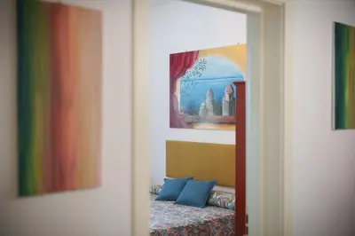 a room with a bed and a painting on the wall at Le Tare B&B in Rome