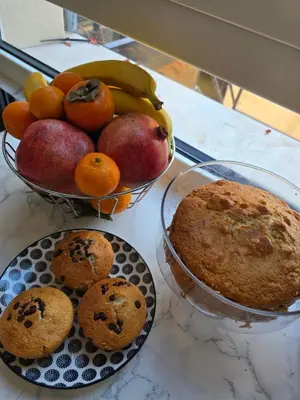 a table with a bowl of fruit and a bowl of muffins at Casa Caudì in Rome