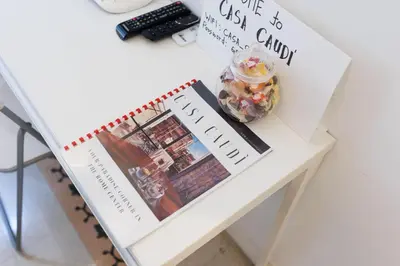a table with a book and a jar of candy on it at Casa Caudì in Rome
