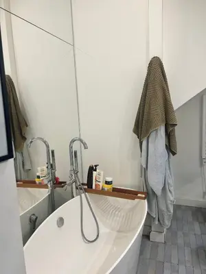 a bathroom with a bath tub and a mirror at Casa Caudì in Rome