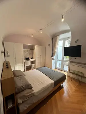 a bedroom with a large bed and a television at Casa Caudì in Rome