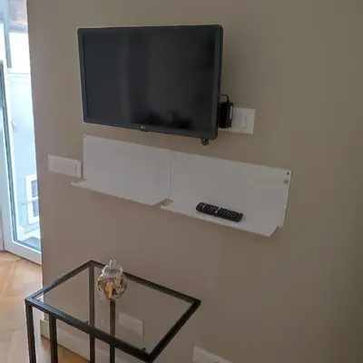 a flat screen tv hanging on a wall at Casa Caudì in Rome