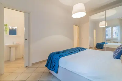 a bedroom with a large bed and a bathroom at Vaticano San Pietro Apartment in Rome