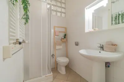 a white bathroom with a toilet and a sink at Vaticano San Pietro Apartment in Rome