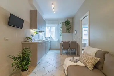a living room and kitchen with a couch and a table at Vaticano San Pietro Apartment in Rome