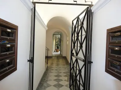 a hallway with a door and a tile floor at Elegante appartamento immerso nei Fori Imperiali in Rome