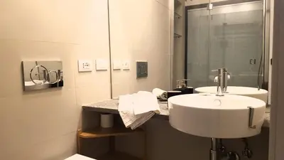 a bathroom with a sink and a mirror at Domus Lupae -live in the heart of Rome in Rome