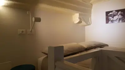a room with a bed in the corner of a room at Domus Lupae -live in the heart of Rome in Rome