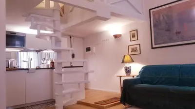 a living room with a white spiral staircase in a room at Domus Lupae -live in the heart of Rome in Rome
