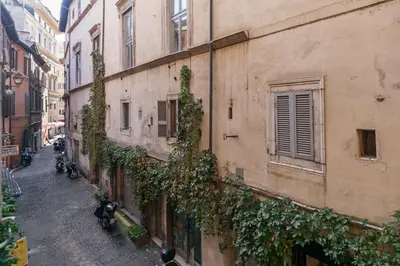 an alley with ivy growing on the side of a building at Domus Lupae -live in the heart of Rome in Rome