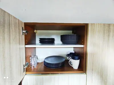 a cabinet with plates and cups and dishes in it at condottieri al pigneto in Rome