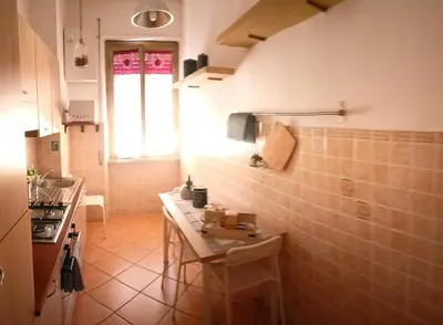 a small kitchen with a table and a window at condottieri al pigneto in Rome