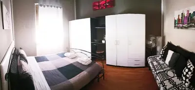 a bedroom with two white cabinets and a bed and a window at condottieri al pigneto in Rome