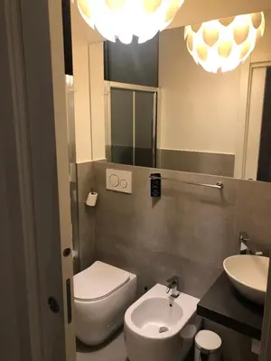 a bathroom with a sink and a toilet and a mirror at Room 76 in Rome