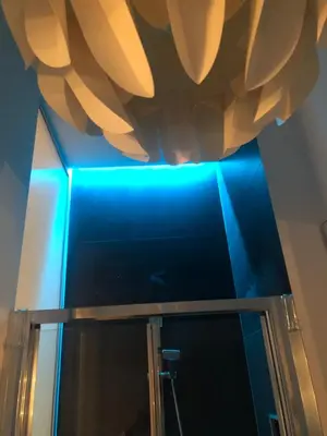 a ceiling with a blue light in a bathroom at Room 76 in Rome