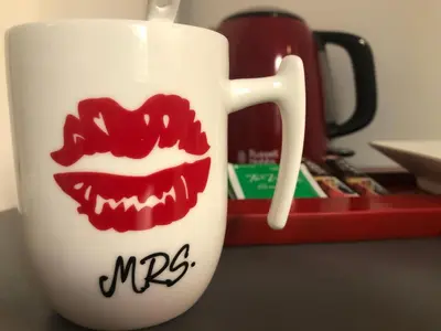 a white mug with red lips painted on it at Room 76 in Rome