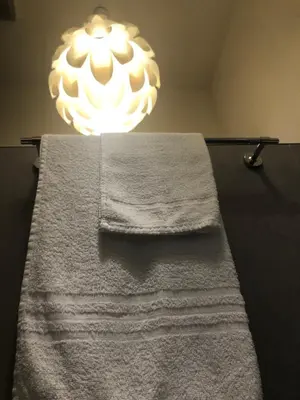 a bathroom with a white towel and a chandelier at Room 76 in Rome