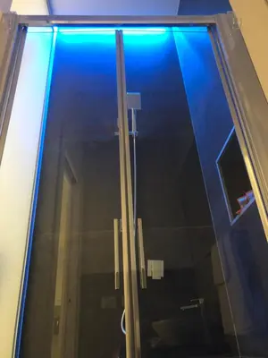 a glass window with a blue light on it at Room 76 in Rome
