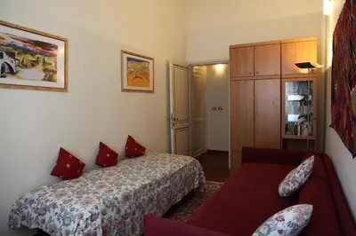 a hotel room with a bed and a couch at Apartment Spanish Steps with panoramic roof-terrace in Rome