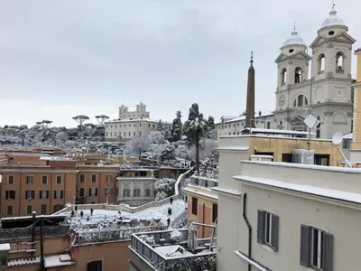 a view of a city with snow covered buildings at Apartment Spanish Steps with panoramic roof-terrace in Rome