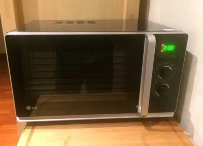 a microwave oven sitting on top of a wooden floor at Apartment Spanish Steps with panoramic roof-terrace in Rome