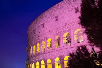 a building with yellow lights on it at night at SECRET GARDEN - Amazing Loft in The Imperial Rome in Rome