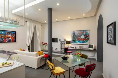 a living room with a couch and a table and chairs at SECRET GARDEN - Amazing Loft in The Imperial Rome in Rome