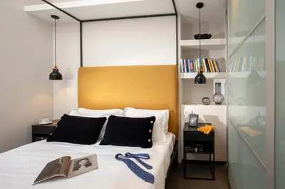 a bedroom with a large bed with a yellow headboard at SECRET GARDEN - Amazing Loft in The Imperial Rome in Rome
