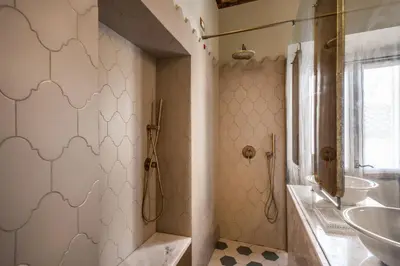 a bathroom with a sink and a tub and a toilet at Febo Decharm apartment in Rome