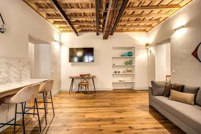 a living room with a couch and a table at Febo Decharm apartment in Rome