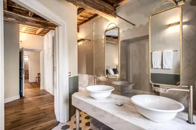 a bathroom with two sinks on a counter at Febo Decharm apartment in Rome