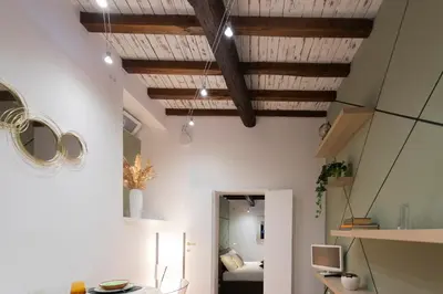 a room with white walls and wooden ceilings at Sofia alla VII Coorte in Rome