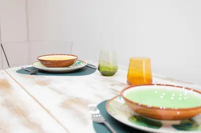 a wooden table with plates and glasses on it at Sofia alla VII Coorte in Rome