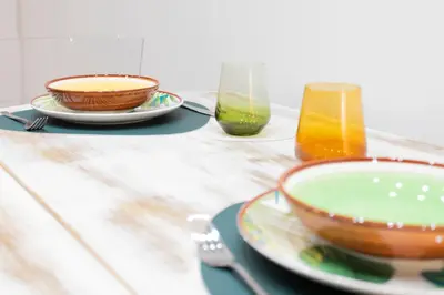 a table with a bowl and two glasses of juice at Sofia alla VII Coorte in Rome